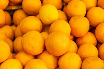 Fresh orange fruits heap and in sales at market,close up taken