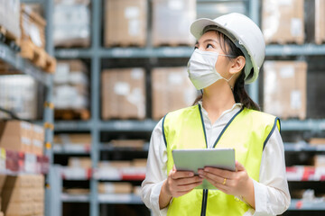 Young asian woman auditor or trainee staff wears mask working during the COVID pandemic in store...