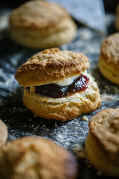 Homemade scone with jam and cream.