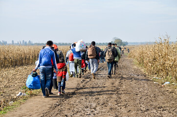 Syrian Refugees Running In Cornfield. Border between Serbia and Croatia. Balkan route. Migrants on...