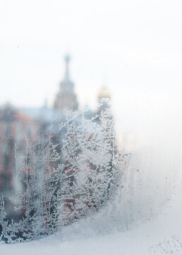 Russian orthodox church through tracery made by frost on a windowpane