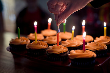 Lighting the candles on birthday cupcakes
