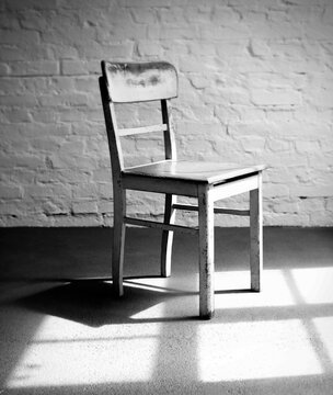 Empty chair in a loft with window light.