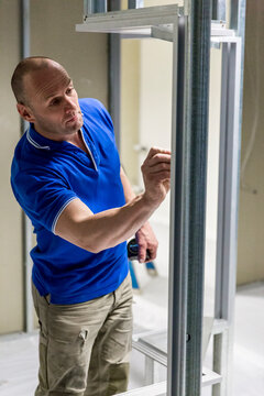 Glazier noting panel identifier on internal frame