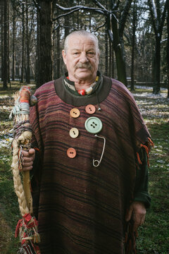 Portrait of eccentric old man with walking stick