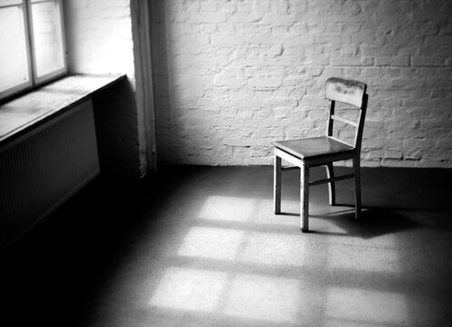 Empty chair in a loft with window light.
