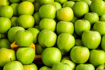Ripe,fresh green apples heap at market,close up taken