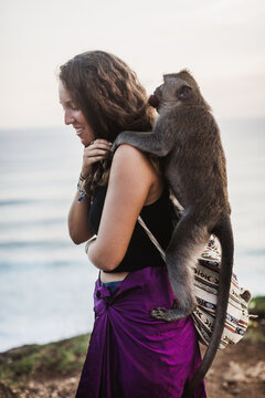Woman playing with a monkey