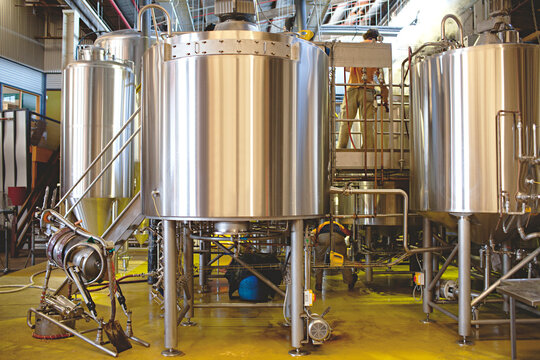 brewery vats and kegs brewing beer at micro brewery