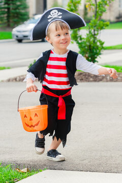 Toddler trick-or-treating in pirate costume