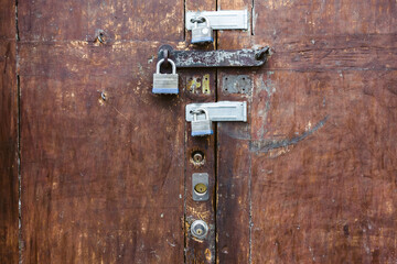 Old wooden door secured with 6 locks