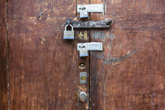 Old wooden door secured with 6 locks