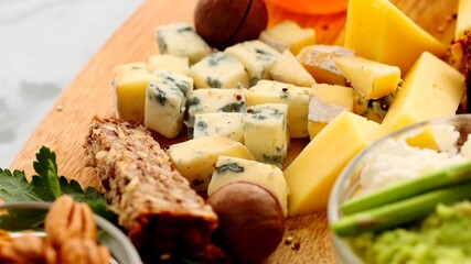 A close up on different cheeses with bread on table