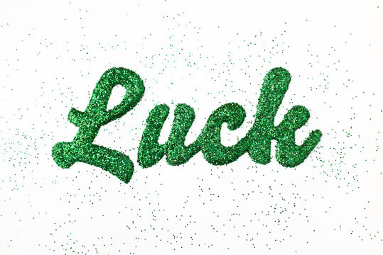 The word ""luck"" spelled with green glitter