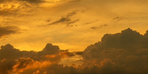 Sunset, bright sky with golden clouds.