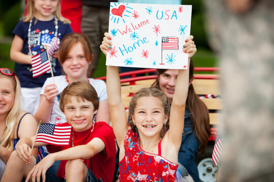 Parade: Girl Holds Up Sign for Soldier in Parade