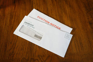 Close-up Of An Eviction Notice In Envelope on Desk