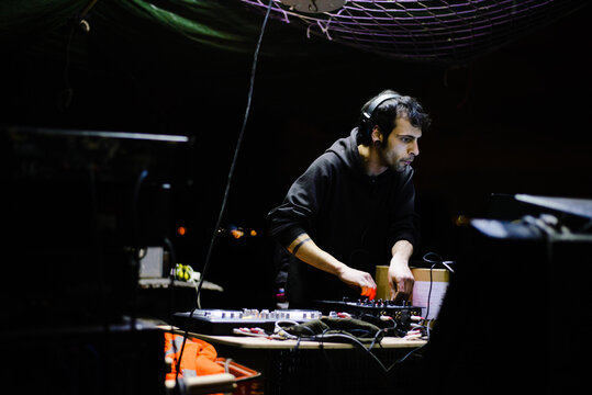 Male Hardcore DJ at a rave party