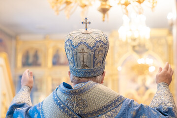 The priest conducts the rite of prayer, inside the Christian church, a soft focus