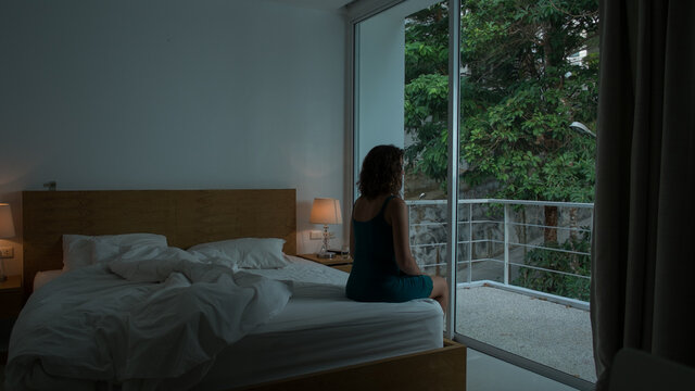 Anonymous Woman Sitting Alone In The Bedroom