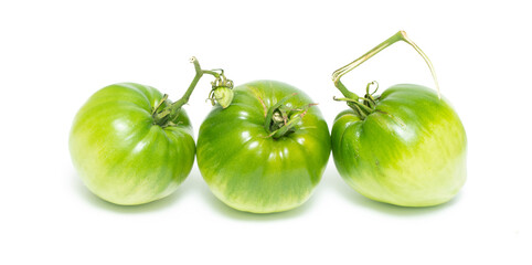 Green tomato isolated on a white background.
