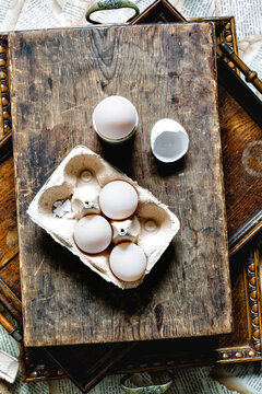 Duck eggs in carton on wooden background.