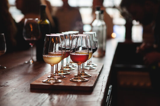 Sampler tray of wine sitting on bar at winery