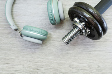 Dumbbell Set with headphone on the wooden floor