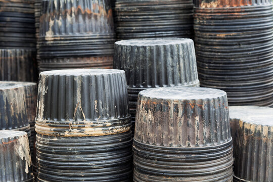 Stacks of overturned used plastic flower pots at a plant nursery