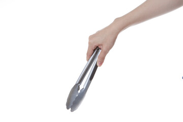 hand holding steel spoon tongs.