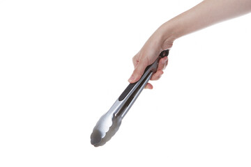 hand holding steel spoon tongs.