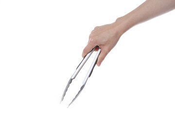 hand holding steel spoon tongs.