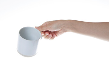 hand holding a white coffee cup.