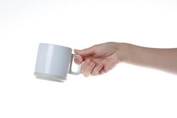 hand holding a white coffee cup.