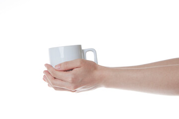 a hand wrapped around a white cup of coffee