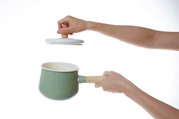 hand holding pot lid.