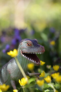 Dinosaur standing between spring weeds