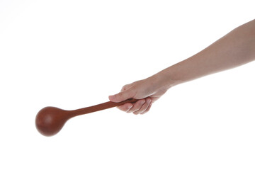 a hand holding a wooden ladle upside down.