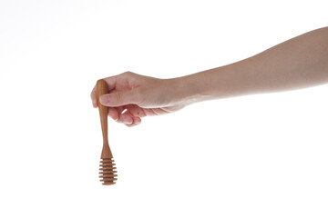 hand holding wooden honey dipper