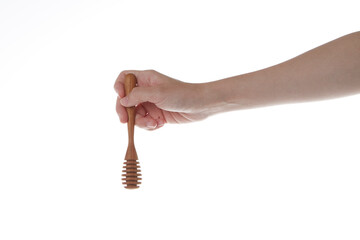 hand holding  wooden honey dipper.