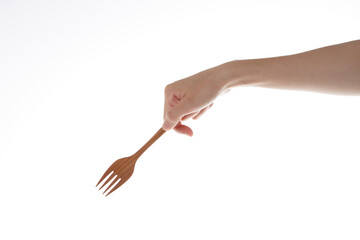 hand holding wooden fork. use the fork.