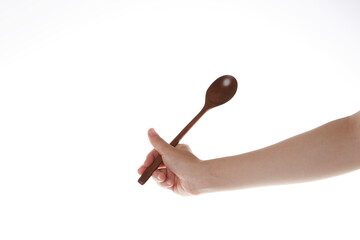 a hand holding a spoon upward.