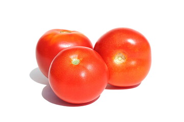Three red ripe tomatoes on a white background