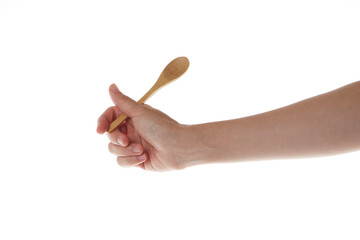 hand holding teaspoon made of wood.
