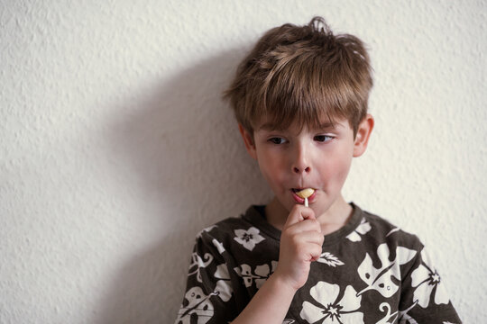 Preschool boy sucking his lollipop