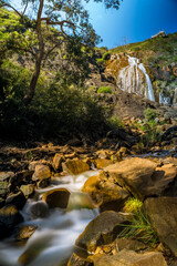 Lesmurdie waterfall in bush forest at regional national park with rock formation and blue sky