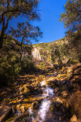 Lesmurdie waterfall in bush forest at regional national park with rock formation and blue sky