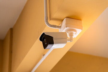 Technician installing IP CCTV camera and water proof box to protect camera is home security system...