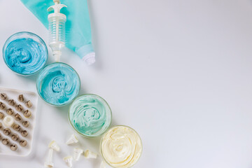 Pastry bag with nozzles and icing on white background.