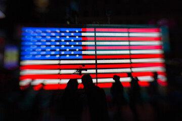 silhouettes of people with American flag in the background